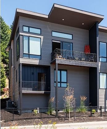 Condo faces Shelton McMurphey Boulevard with entry and garage in back.