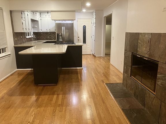 Kitchen from the dining area and showing the 2-sided wood burning fireplace