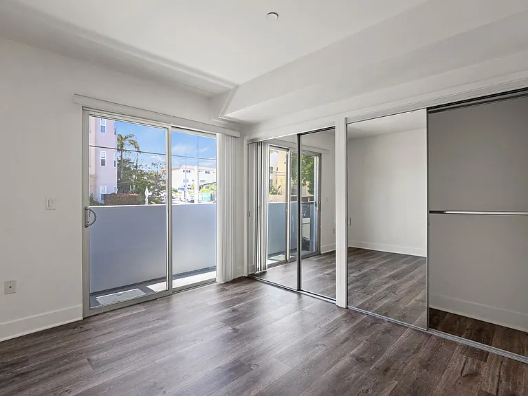 Bedroom with Two Mirrored Closets and Balcony