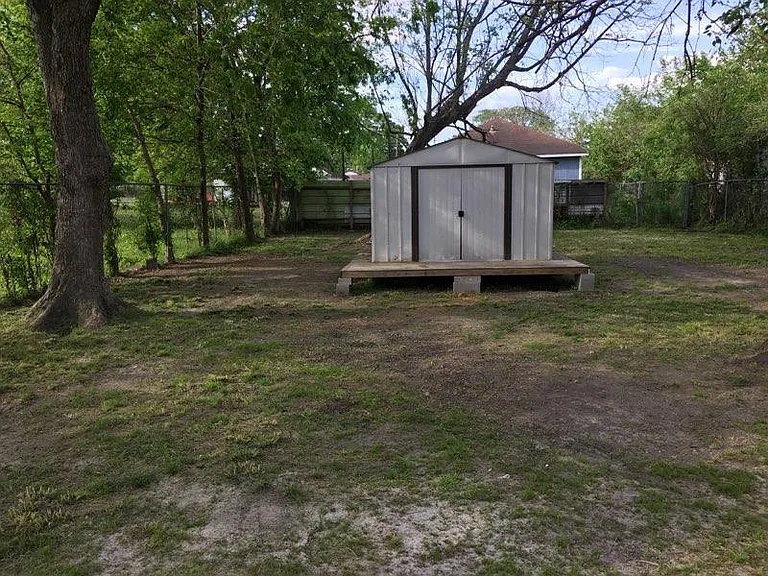 Huge backyard fully fenced with storage shed