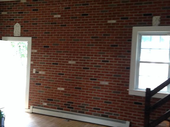 Main entrance door and brick wall