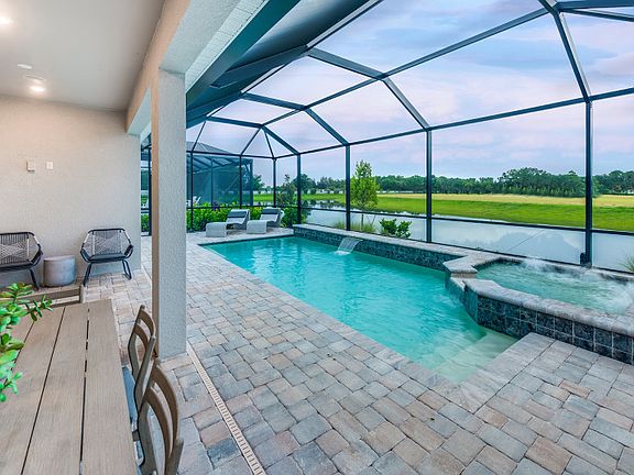 Covered lanai with screened-in pool spa