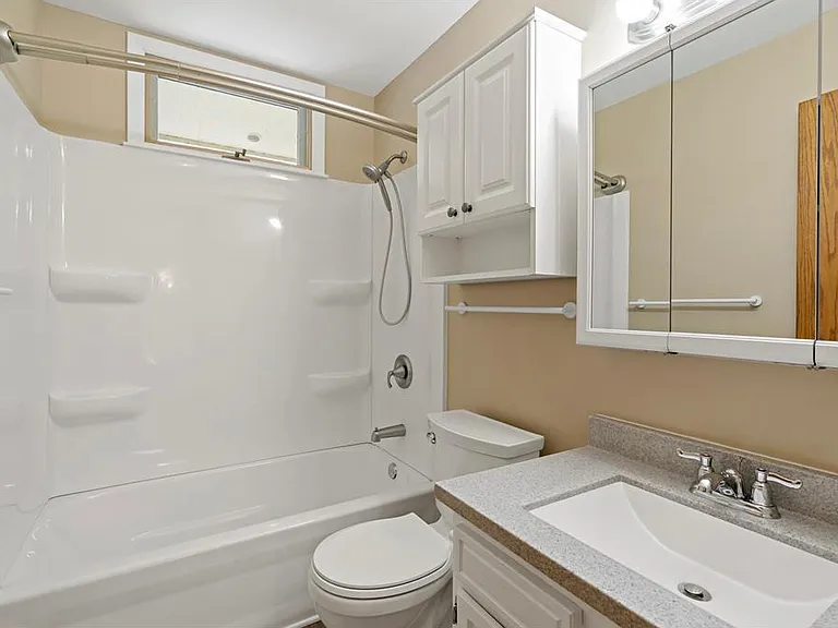 Upper level full bath with updated vanity, tub, and shower surround