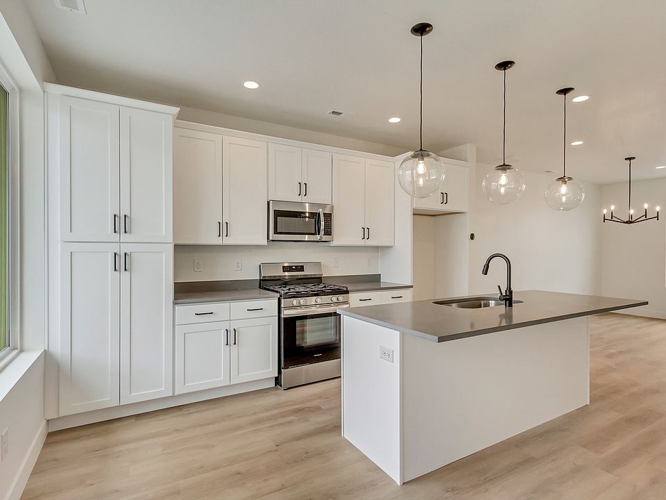 Kitchen with white cabinets and center island in a sego home