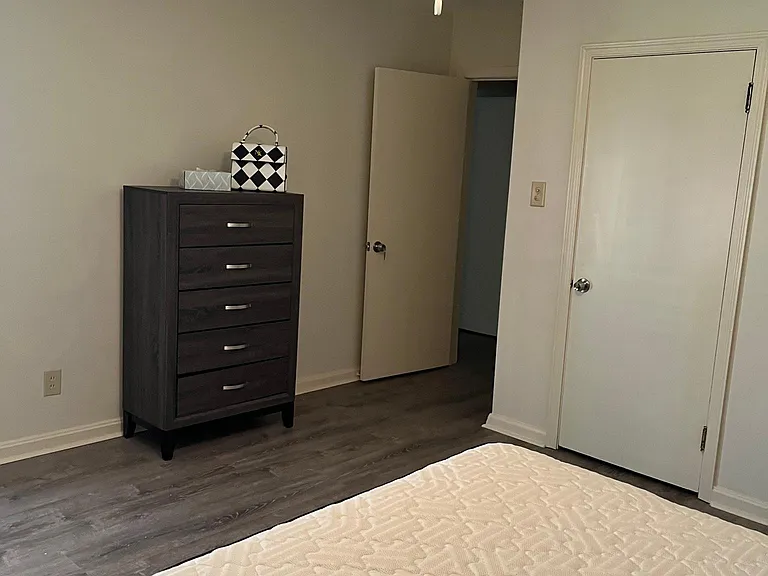 Room B - Dresser and entrance to community hallway to living room and kitchen.