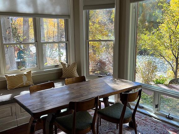 Dining area with window seat and storage. View of river and private patio on the river.