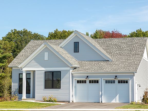 Modern single-story house at 385 Beaudry Lane with gray siding, black trim, and a double garage unde