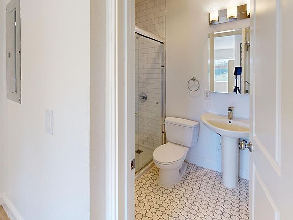 Bathroom with a toilet, sink and shower