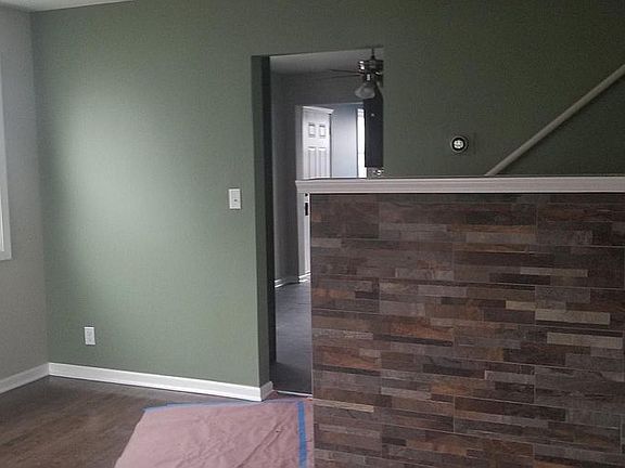 Entrance way from the living room to the kitchen, staircase leading to the 2nd and 3rd floor.