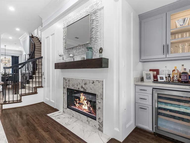 Elegant 2nd-floor living space featuring a cozy fireplace and seamless flow.