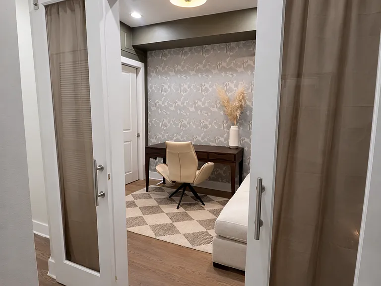 The guest room has sliding glass barn doors and currently includes a desk, but a full-sized bed can be provided on request