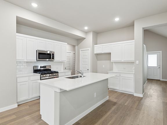 Kitchen in the Elm home plan by Trophy Signature Homes - REPRESENTATIVE PHOTO