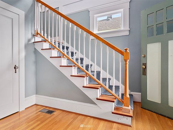 Grand front staircase taking you upstairs to primary and second bedroom