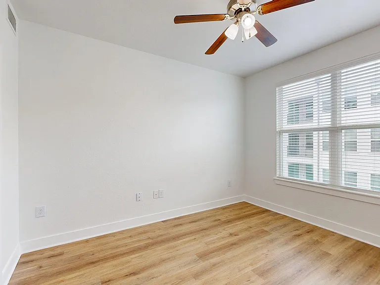 Spacious apartment Bedroom with wood style floor.