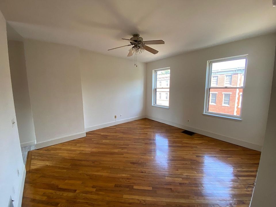 Bedroom, Hardwood floor, Ceiling fan with light. Windows with storm windows and screens. Bright room