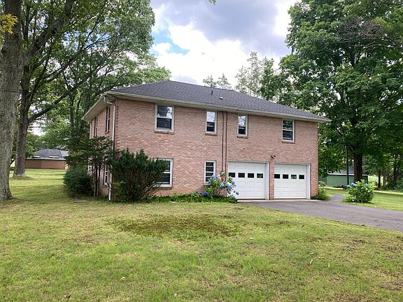 Long private drive leads to garage beneath
