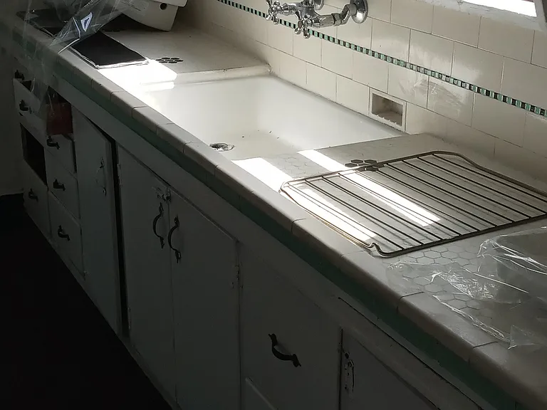 Kitchen sink. New blinds are being put on all windows in the apartment/