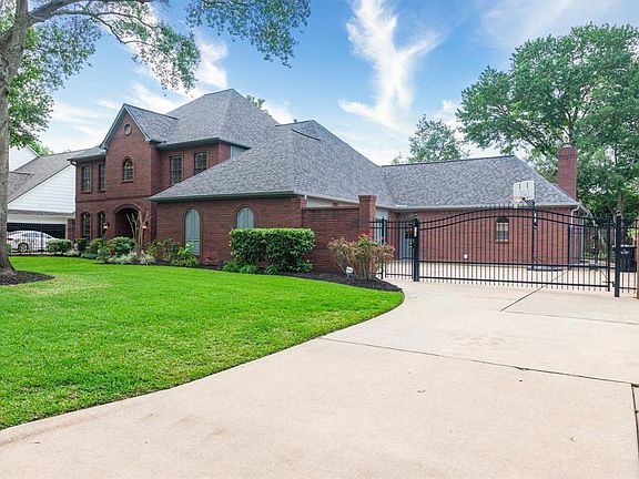 Wrought iron fencing is located on this right side as well. The driveway gate provides a touch of elegance as well as security for pets and kids playing in the motor court area.