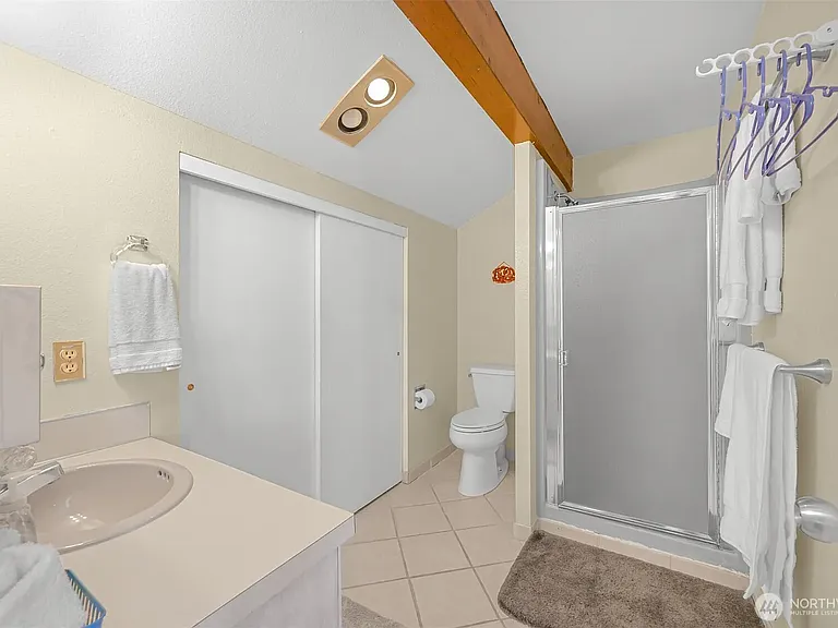 Loft bathroom with large closet