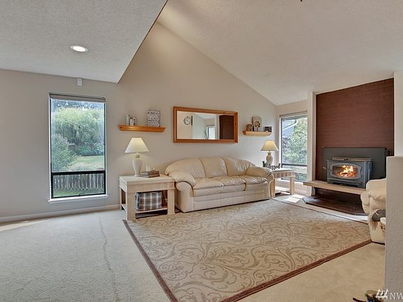 Light & Bright Living Room with Vaulted Ceiling and cozy wood burning stove.