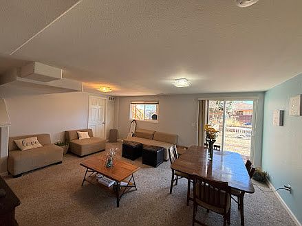 Living and Dining room areas looking outdoors and towards entrance.