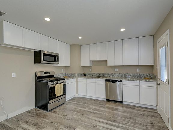 Remodeled kitchen stainless steel appliances granite counter new cabinets.