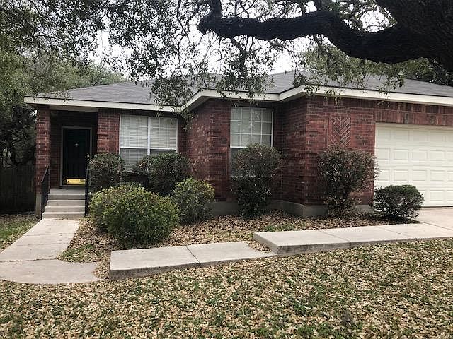This is a picture of the front of the house. There is a large tree to your right and another large tree to your left just outside the picture. The home is only five houses from the entrance to the community.