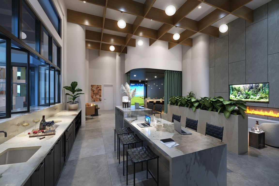 The expansive clubroom features lounge seating and a golf simulator, offering a versatile space for recreation and socializing.