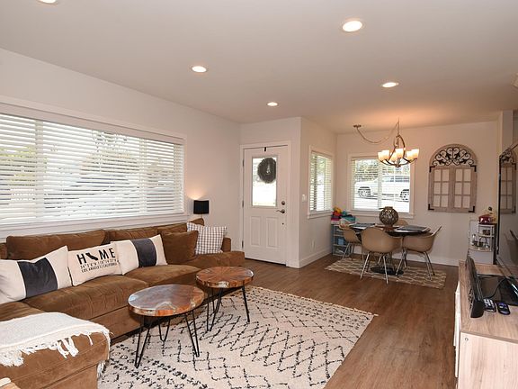 View of the living room looking toward the front door and eating area.