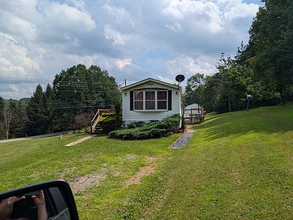 Rear deck and bay window can be seen from this view.
