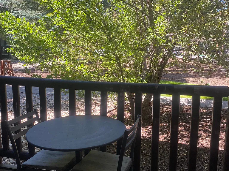 Table and two chairs outside.