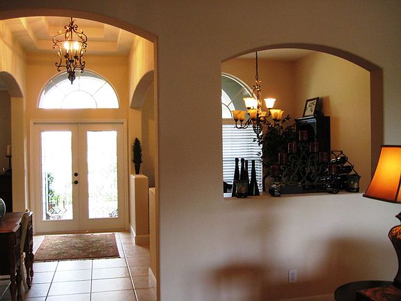 Leaded Glass double door entry with arched windows, coffered ceiling!