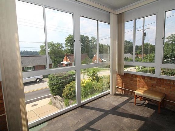 HUGE windows let in light and fresh air to make this sun room feel even larger!