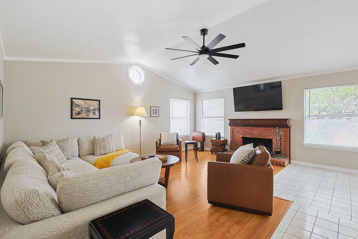Unwind in a spacious, open-concept living room featuring plenty of comfortable seating meaning there is room for everyone to relax and make lasting memories together. - 2502 High Hollow Dr