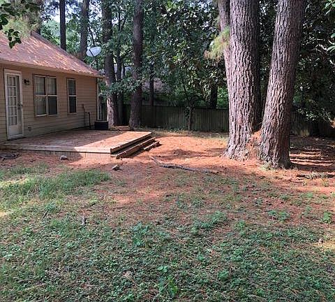 Shady backyard. New wood fence along the back and side. Deck off back door. Chain link fence on the front