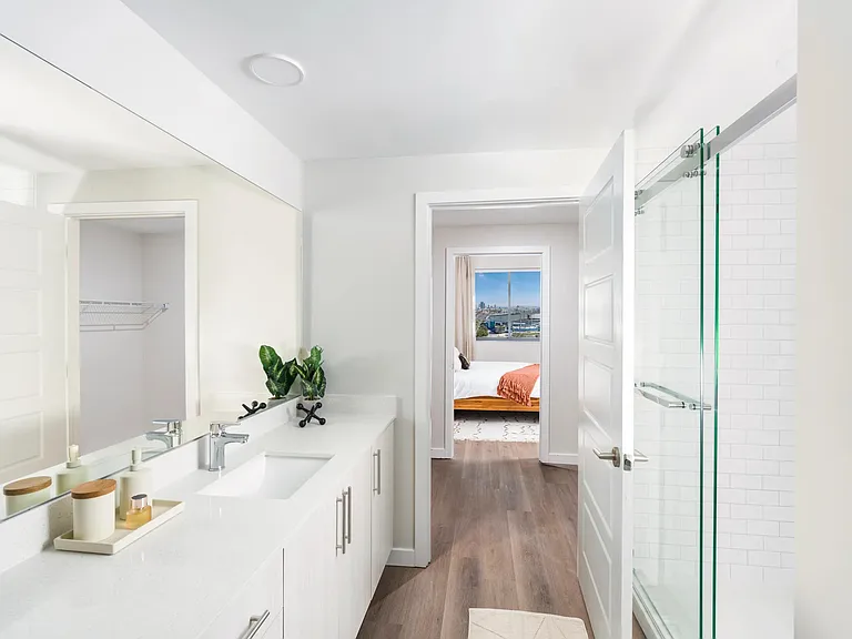 Enjoy the ease of a dual entrance bathroom with a pass-through closet for added comfort.