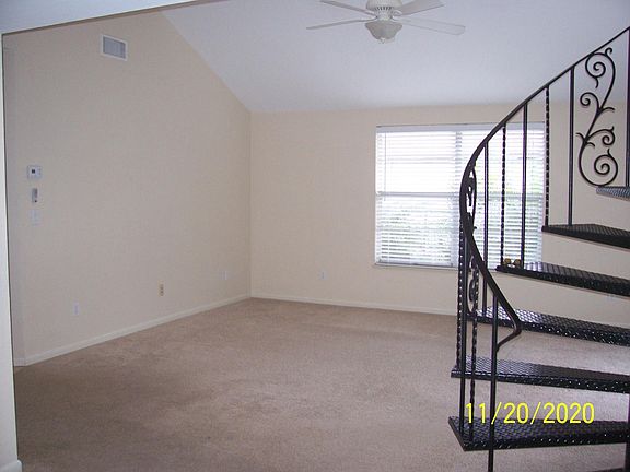 Livingroom with spiral staircase to 3rd bedroom.