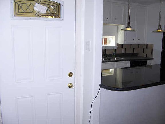 Secure entry door leads to covered porch.