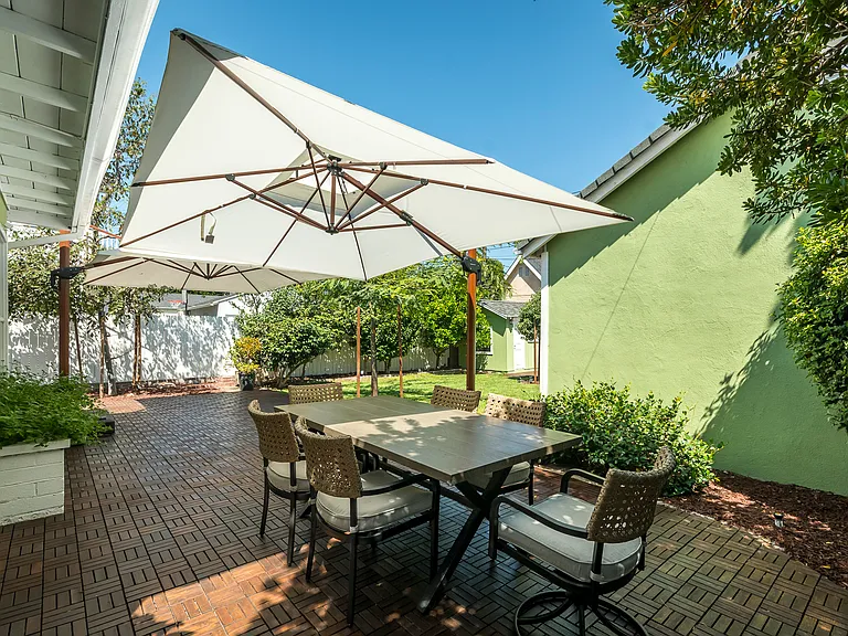 Private backyard retreat featuring a large patio for dining and entertaining, plus a lush lawn for play and relaxation.
