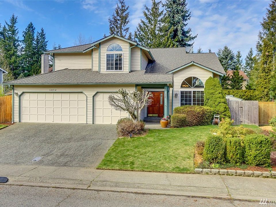 Welcome home to Fairwood Firs and this lovely 4 bedroom, 3 bathroom home. The covered front porch is a great place to sit and relax. Enter to soaring vaulted ceilings and abundant windows that allow natural light to flow throughout. This home is a welcoming gathering place with open sightlines between the living and dining room. The elevated dining room creates a grand entertaining space. The lovely eat-in kitchen opens to the family room and lower level of the home where you will also find a dry bar, guest bedroom, 3/4 bathroom and utility room.