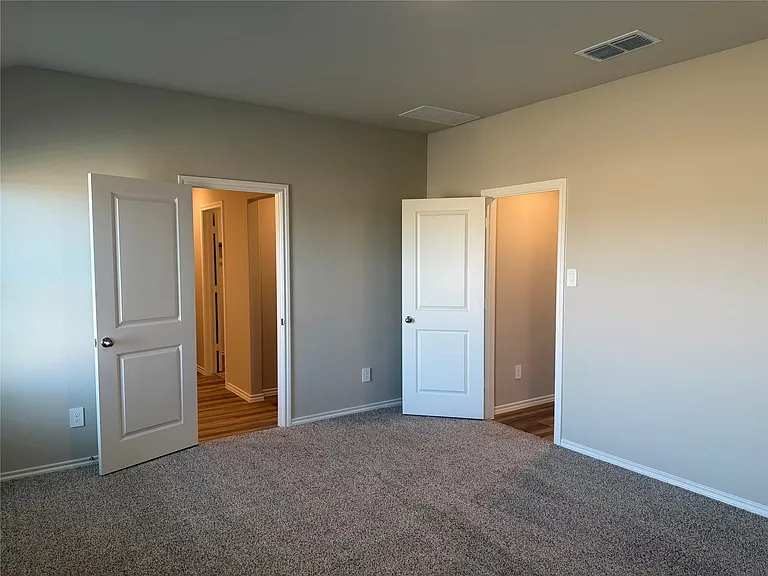 Neutral-toned walls complement the gray carpeting
