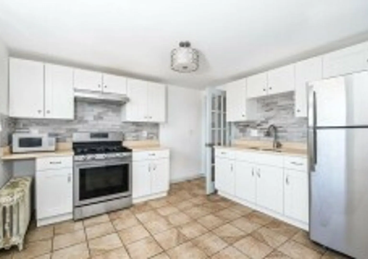 Renovated 4BR with In-Unit Laundry Near Moody Street — Photo 2