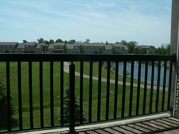 balcony overlook field, jogging track and pond next to it