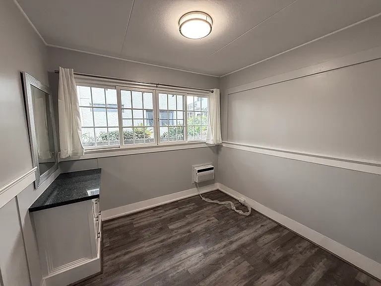 Bedroom #3 with AC unit, built-in drawers, and closet!
