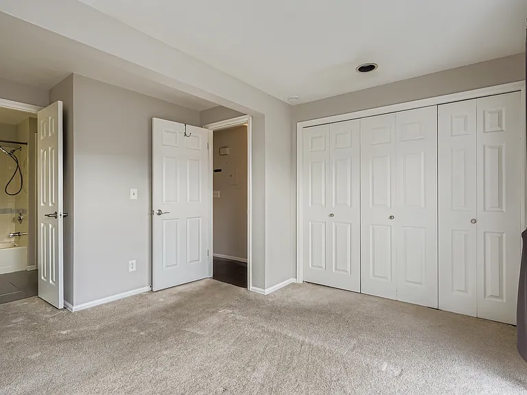 En-suite bathroom that is also accessed by guests near the kitchen.