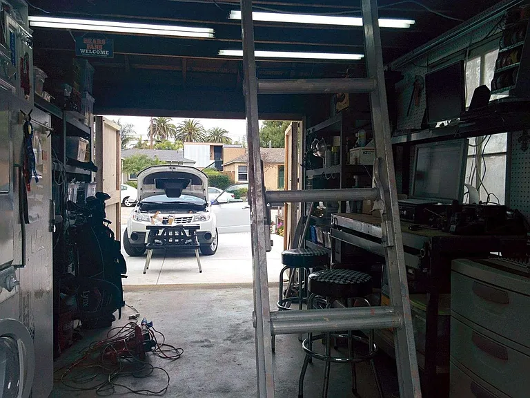 Large garage for one car and washer and dryer hook ups. with up the ladder storage loft.