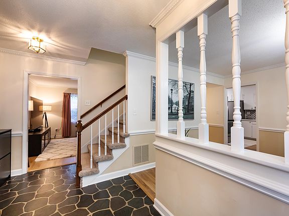 Walk in to dining room on Right and one of the sitting areas straight ahead. Stairs lead to 4 bedrooms