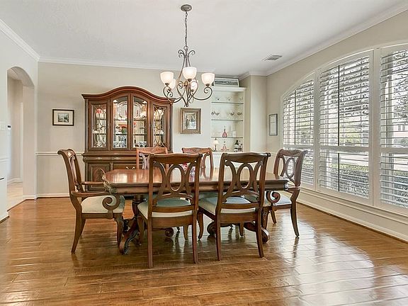 Formal dining room with hand scrapped hardwood floors and tons of natural light flowing through.