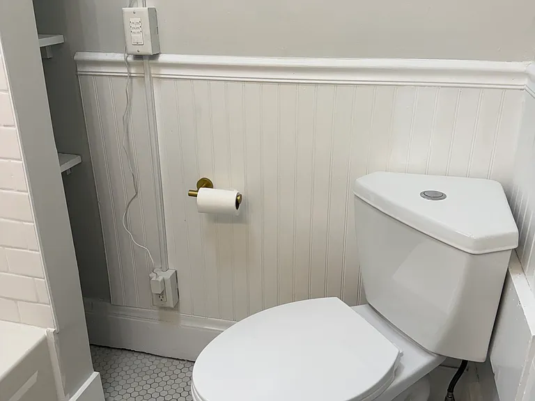 bathroom toilet. towel storage area