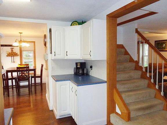Open stairway between the living room and kitchen.